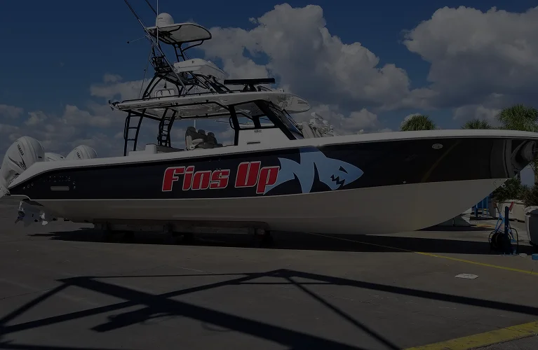 Fins Up fishing boat with shark graphic
