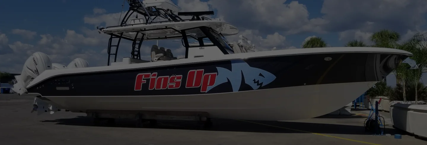 Fins Up fishing boat with shark graphic