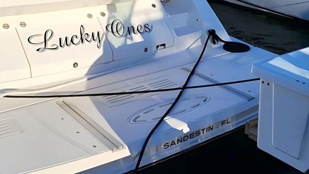 Boat transom with “Lucky Ones” lettering and Sandestin, FL detail