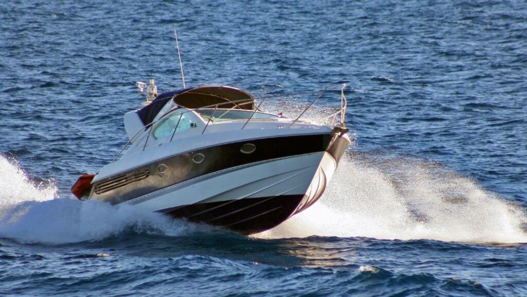 Black and white speedboat on open water showcasing sleek finish with marine vinyl wrap material