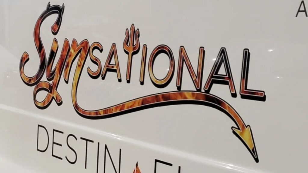 Custom “Synsational” boat name lettering with flame colors, a trident detail, and an arrow flourish