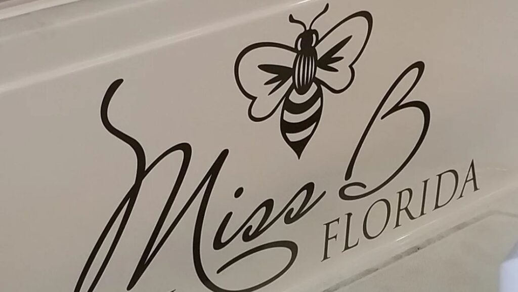 Elegant “Miss B” script boat lettering with a bee icon and Florida beneath it