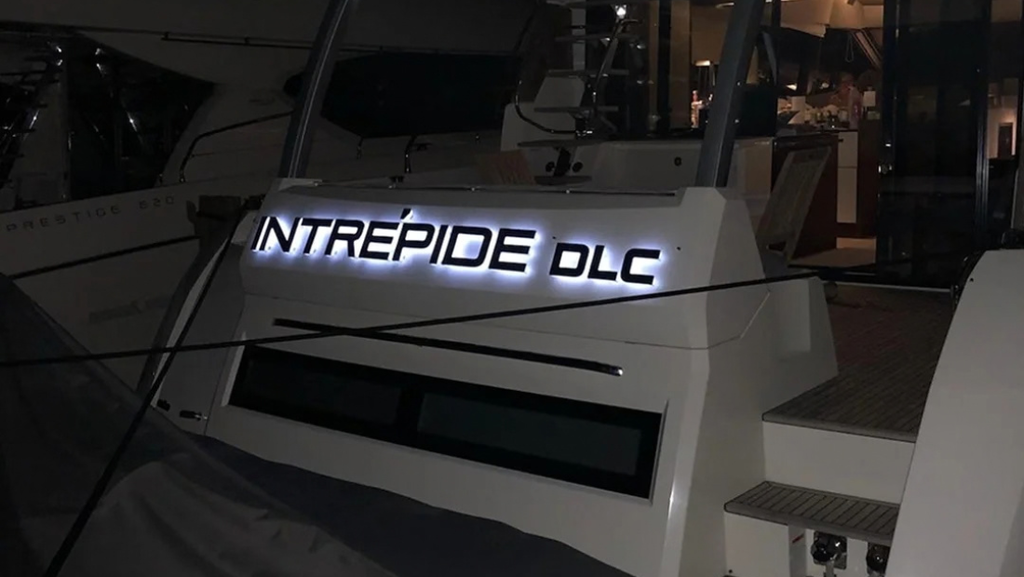 Illuminated stainless steel INTREPIDE DLC boat name lettering at night