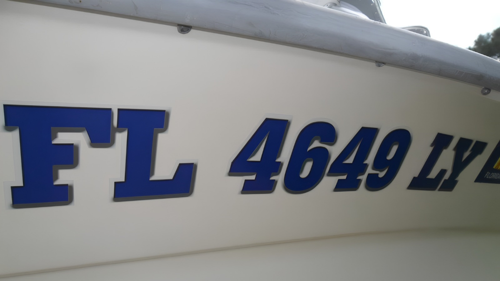 Close-up of blue Florida boat registration lettering FL 4649 LY on a white fiberglass hull.